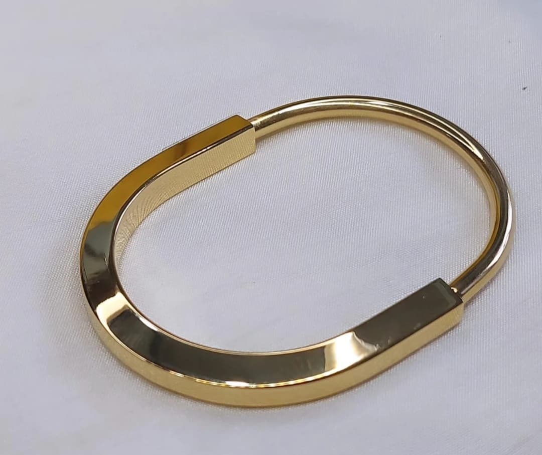 Striking Gold-Tone Statement Kada with a bold design.