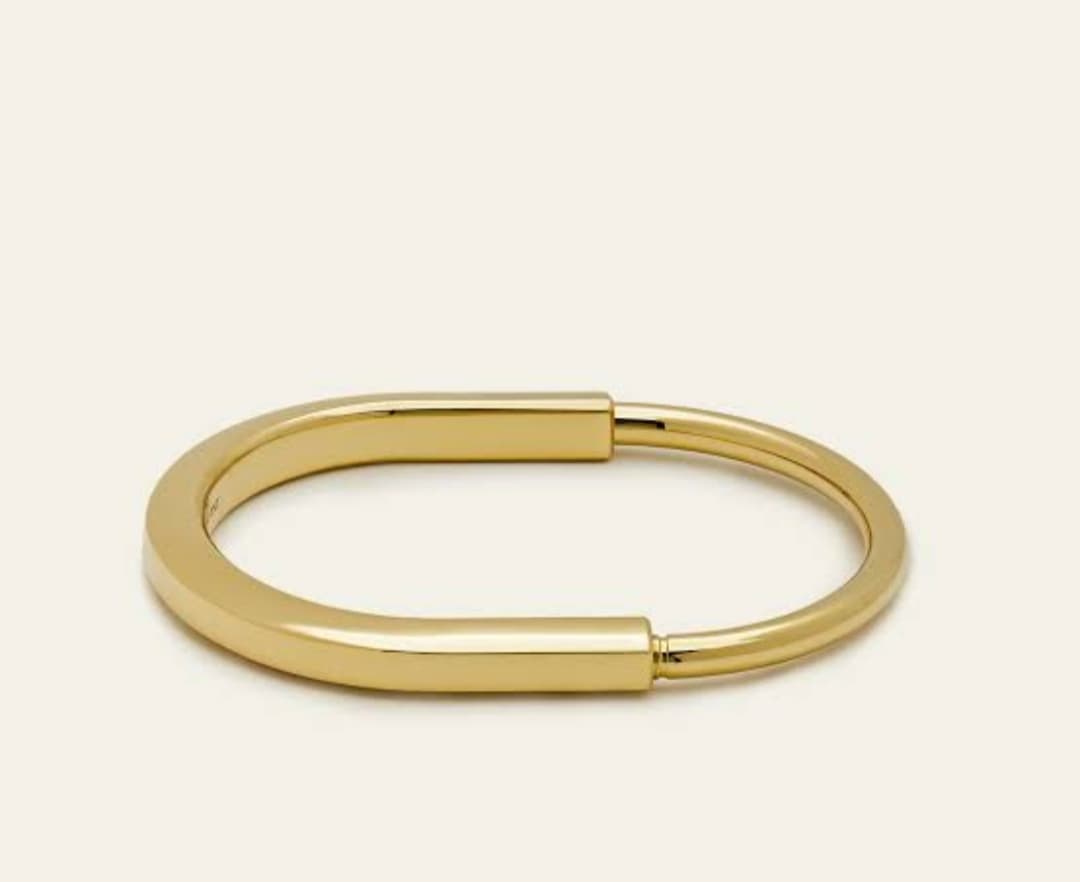 Striking Gold-Tone Statement Kada with a bold design.